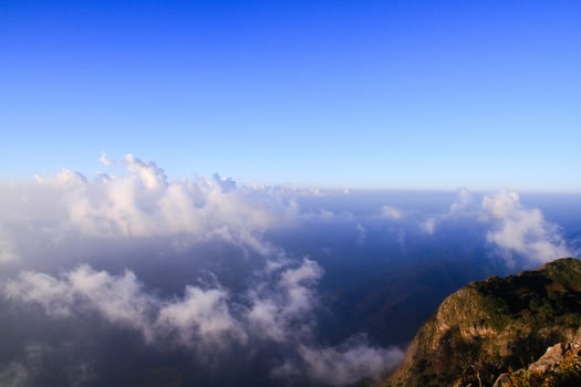 Sunrise in morning with sky and cloud on the mountain. Sunray with Fog and mist cover the jungle hill in Thailand photo