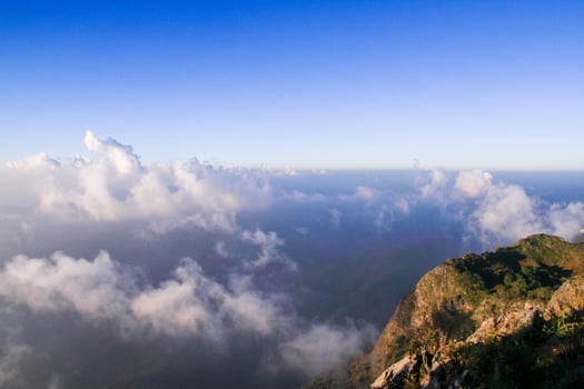 Sunrise in morning with sky and cloud on the mountain. Sunray with Fog and mist cover the jungle hill in Thailand photo