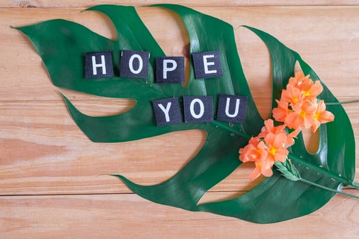 Hope you tag with flower on wood table. photo