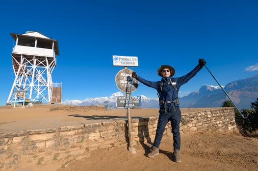 A young traveller trekking in Poon Hill view point in Ghorepani, Nepal photo