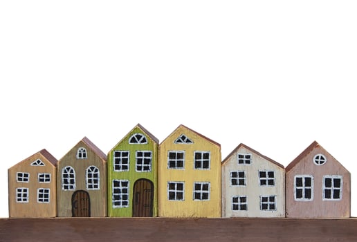 Wooden toy houses on a white background. Miniature town made of wood. photo