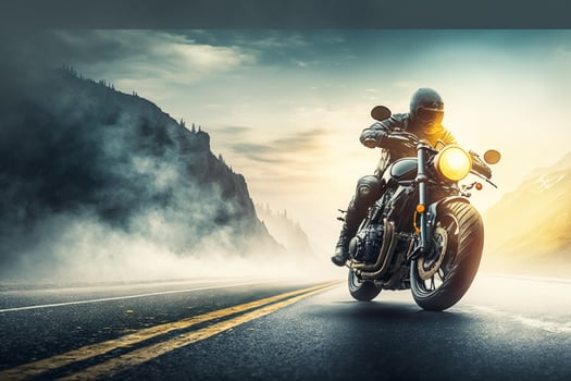 Motorcycle rider on the road in the mountains at sunset time. photo