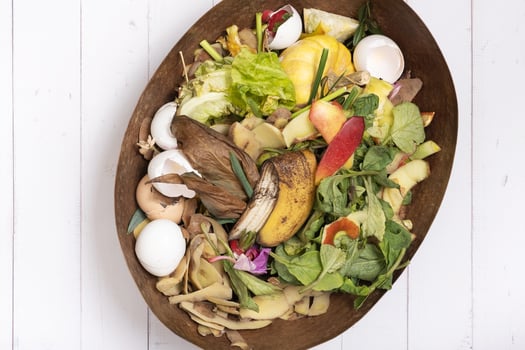 Organic garbage for compost on a wooden background. Composting concept flat lay, top view photo