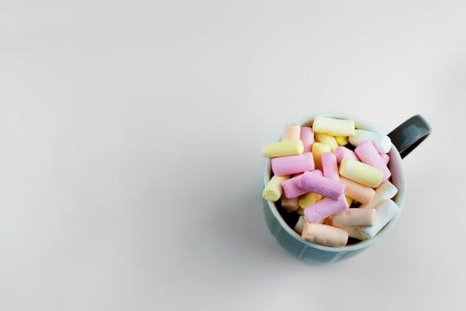 the cup is photographed from above. Multicolored marshmallows in a cup photo