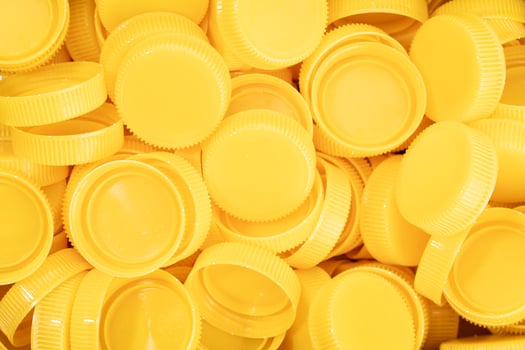 Yellow plastic screw caps background photo