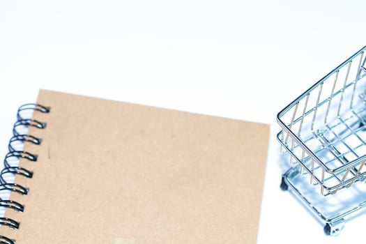 miniature shopping cart on isolate background photo