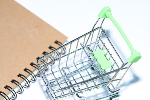 miniature shopping cart on isolate background photo
