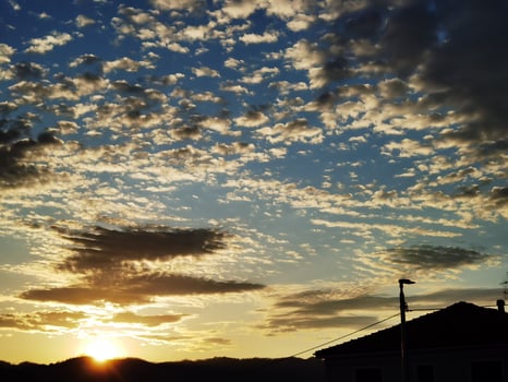 beautiful sunset with bright colors of an intense yellow, in the Ligurian hinterland on a beautiful and warm spring day of 2023 photo