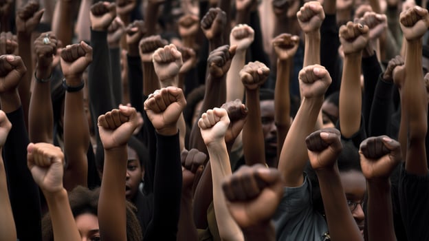 Revolutionary Voices, Protesting Crowd with Raised Fists on City Street. photo