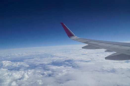 Flying Plane - Wing and Clouds photo