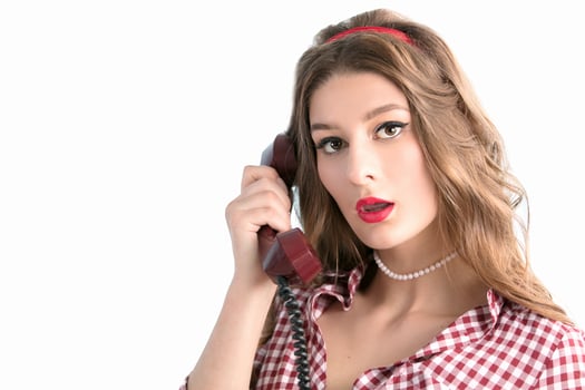 Woman in the style of the fifties. Beautiful retro woman speaks on the phone. photo