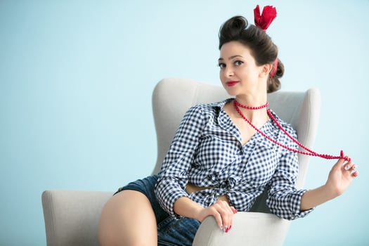 Retro woman with bright beads. Beautiful girl in the style of the fifties. photo