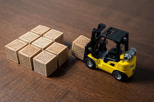 A forklift transports and places boxes. Order for shipment. Production and freight of goods. Increase in imports and exports. The work of the transport department of the enterprise. photo