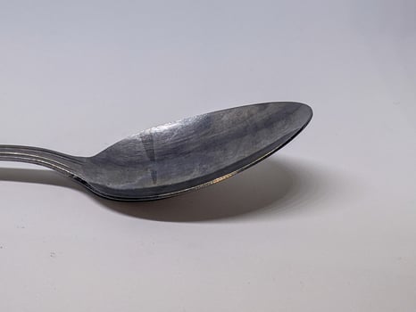 A close up of spoon with white background photo
