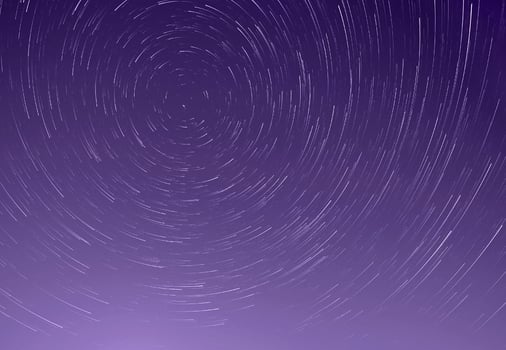 trails of stars in night sky photo