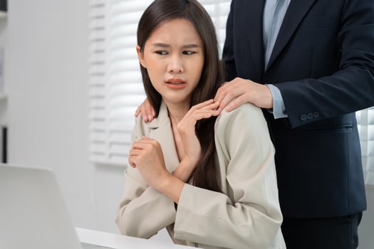 businessman sexually harassed a female colleague by touch her shoulder. Sexual harassment in office. Women feel anxious and stressed from being harassed. molest, assault, inappropriate, discrimination photo