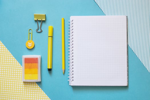 School supplies. Yellow and blue colors. Empty notebook. Flat lay composition. Space for text. photo