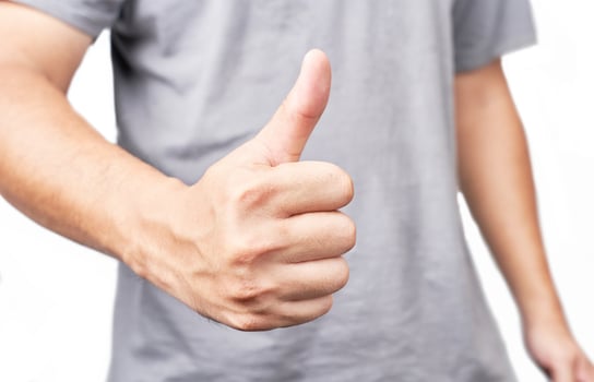 Asian man showing thumbs up closeup shot isolated on white background photo