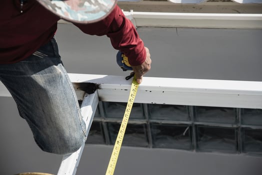 onsite construction worker with steel roof structure installation, residential building contractor job photo