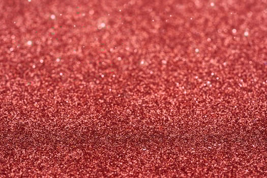 red dust spark glitter texture christmas abstract sparkle background. close up red dust spark glitter texture christmas abstract sparkle background. red bokeh glitter photo