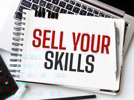 Keyboard of laptop, calculator, pencil and notepad with text sell your skills on the white background photo