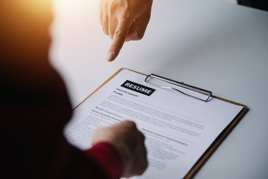 Businessman or job seeker review his resume on his desk before send to finding a new job with pen, necktie, glasses and digital tablet. photo