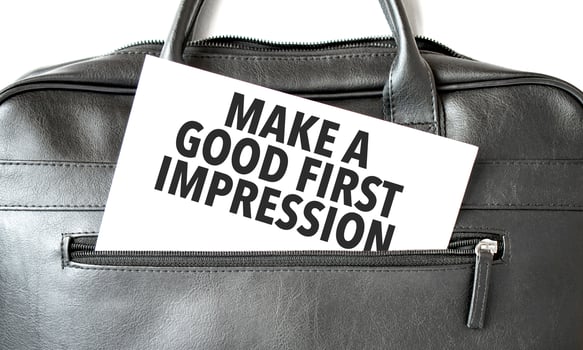 Text Make a good first impression writing on white paper sheet in the black business bag. Business concept photo