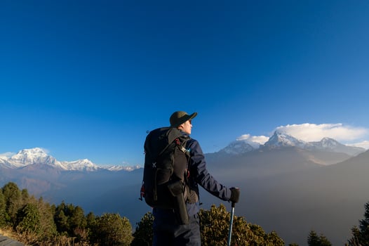 A young traveller trekking in Poon Hill view point in Ghorepani, Nepal photo