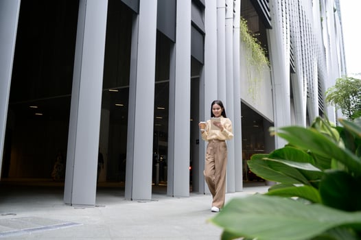 A young businesswoman is working in modern city downtown of Singapore photo