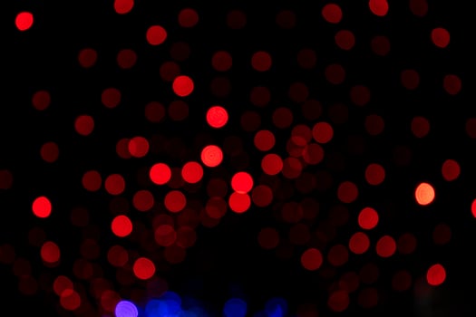 Red Defocus Abstract bokeh light effects on the night black background texture photo