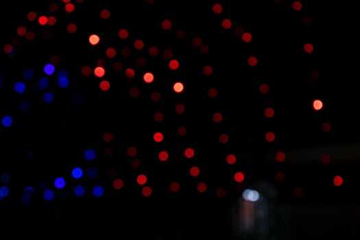 Red Defocus Abstract bokeh light effects on the night black background texture photo