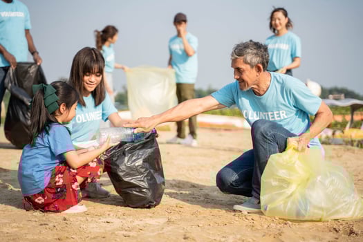 Environmentally conscious volunteers cleaning beach from trash nature protection photo