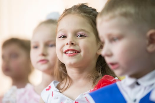 Story of children close-up. Smiling face of a preschool girl. photo