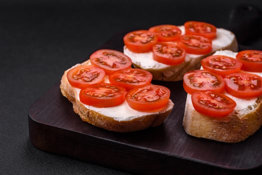 Delicious crispy grilled toast with cheese and cherry tomatoes photo