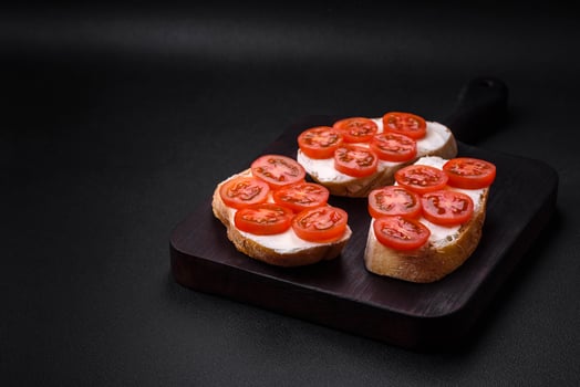 Delicious crispy grilled toast with cheese and cherry tomatoes photo