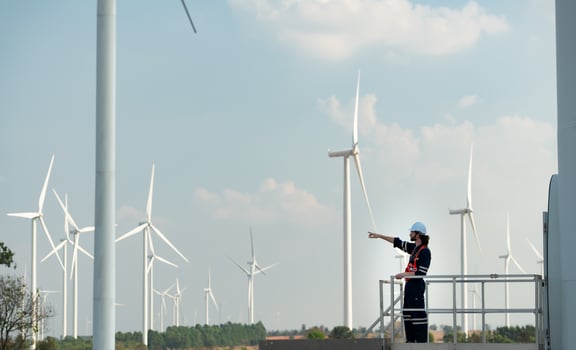 Engineer at Natural Energy Wind Turbine site with a mission to climb up to the wind turbine blades to inspect the operation of large wind turbines that converts wind energy into electrical energy photo