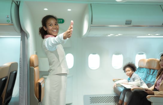 Flight attendants show how to use safety devices and recommend emergency exits. photo