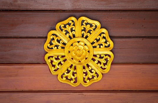 Pattern of gold flower carved on wood for decoration photo