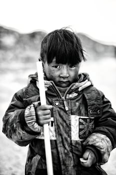 A young shepherd boy in a mountain village in Tibet photo