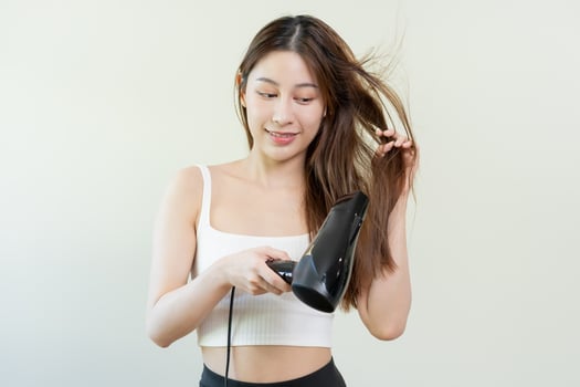 Hair Dryer, beautiful happy, asian young woman, girl hand in using, holding hairdryer to dry, blowing blonde long straight after shower at home. Hairdressing, hair treatment isolated on background. photo