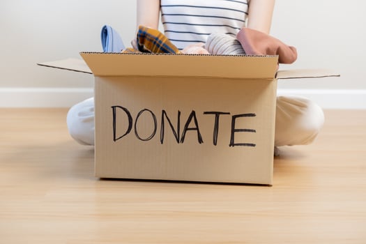 Recycling, Donation for poor, asian young woman, girl sitting pack on floor at home, put on stuff into donate box with second hand clothes, charity helping and needy people. Reuse recycle, moving. photo