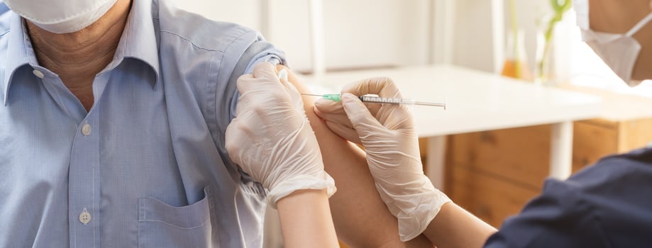 Covid-19,coronavirus, elderly asian adult man getting vaccine from doctor or nurse giving shot to mature patient at clinic. Healthcare, immunization, disease prevention against flu or virus pandemic. photo