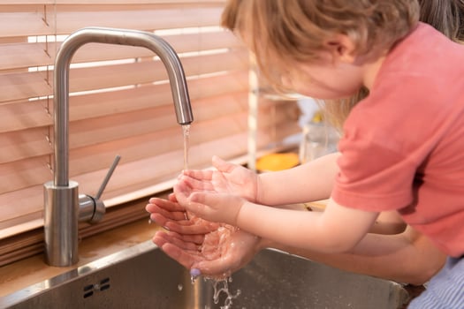 Mother and child wash your hands thoroughly in the sink before entering the kitchen photo