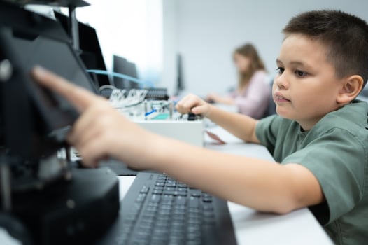 Youngsters utilizing the hand robot technology are having fun learning the electronic circuit board and hand robot controller of robot technology, which is one of the STEM courses. photo