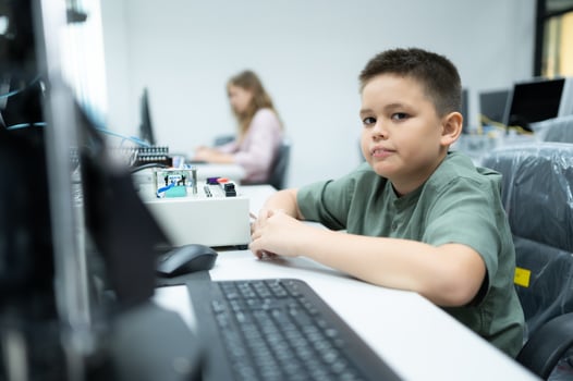 Youngsters utilizing the hand robot technology are having fun learning the electronic circuit board and hand robot controller of robot technology, which is one of the STEM courses. photo