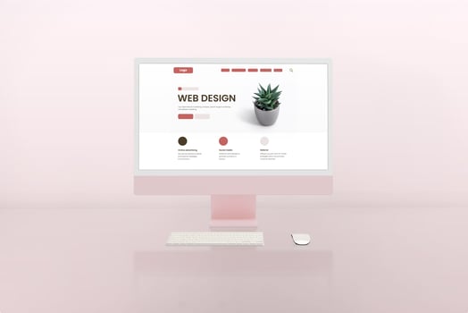 Web design studio with modern computer display and web page layout concept on it. Pink display and background photo