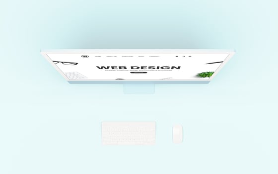 Web design studio concept page on the screen, with a keyboard and mouse beside. The flat lay composition includes a blue desk. Digital rendering, UX, UI, and modern web design photo