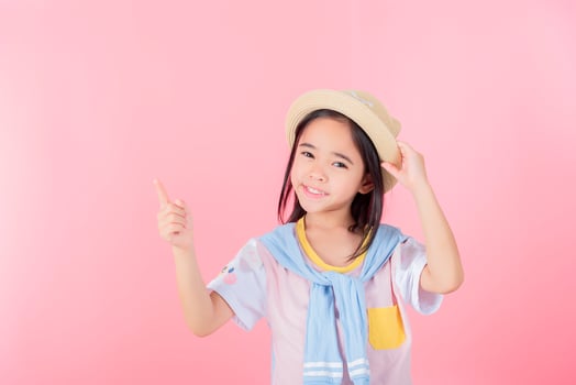 Image of Asian child posing on Pink background photo