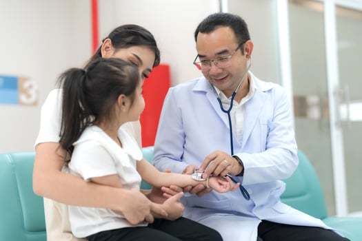 The pediatrician examined the health of the girl photo