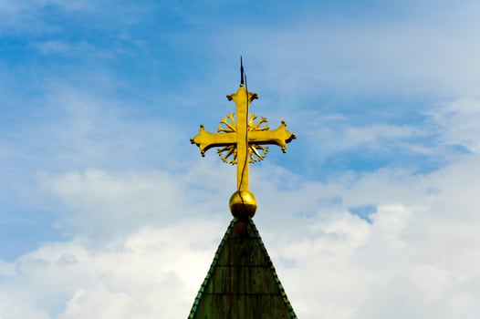 Golden cross over the sky photo